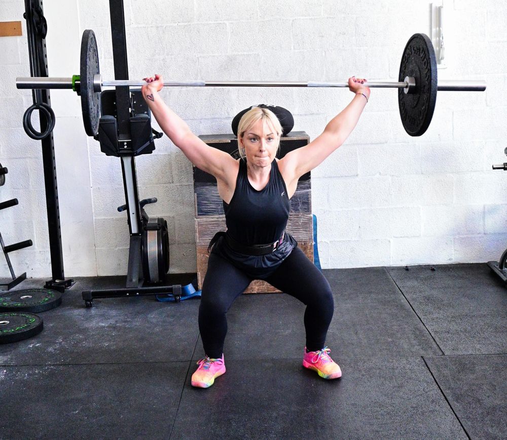 Jo holding an overhead squat
