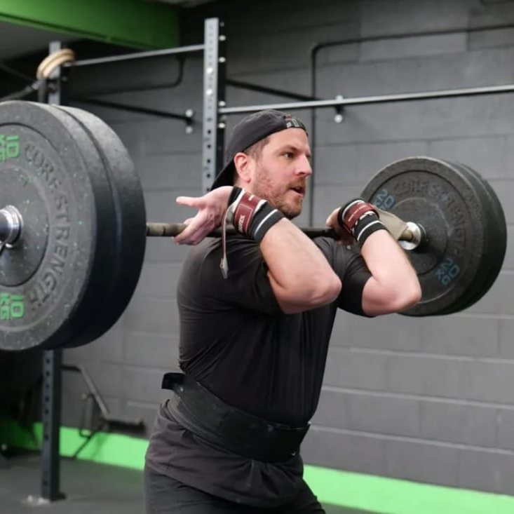 Ryan front squatting a loaded barbell