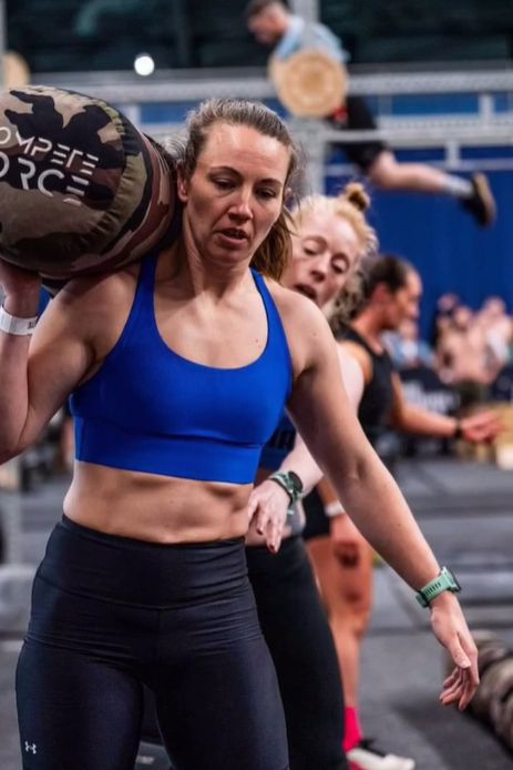 Sam carrying a sandbag at a competition