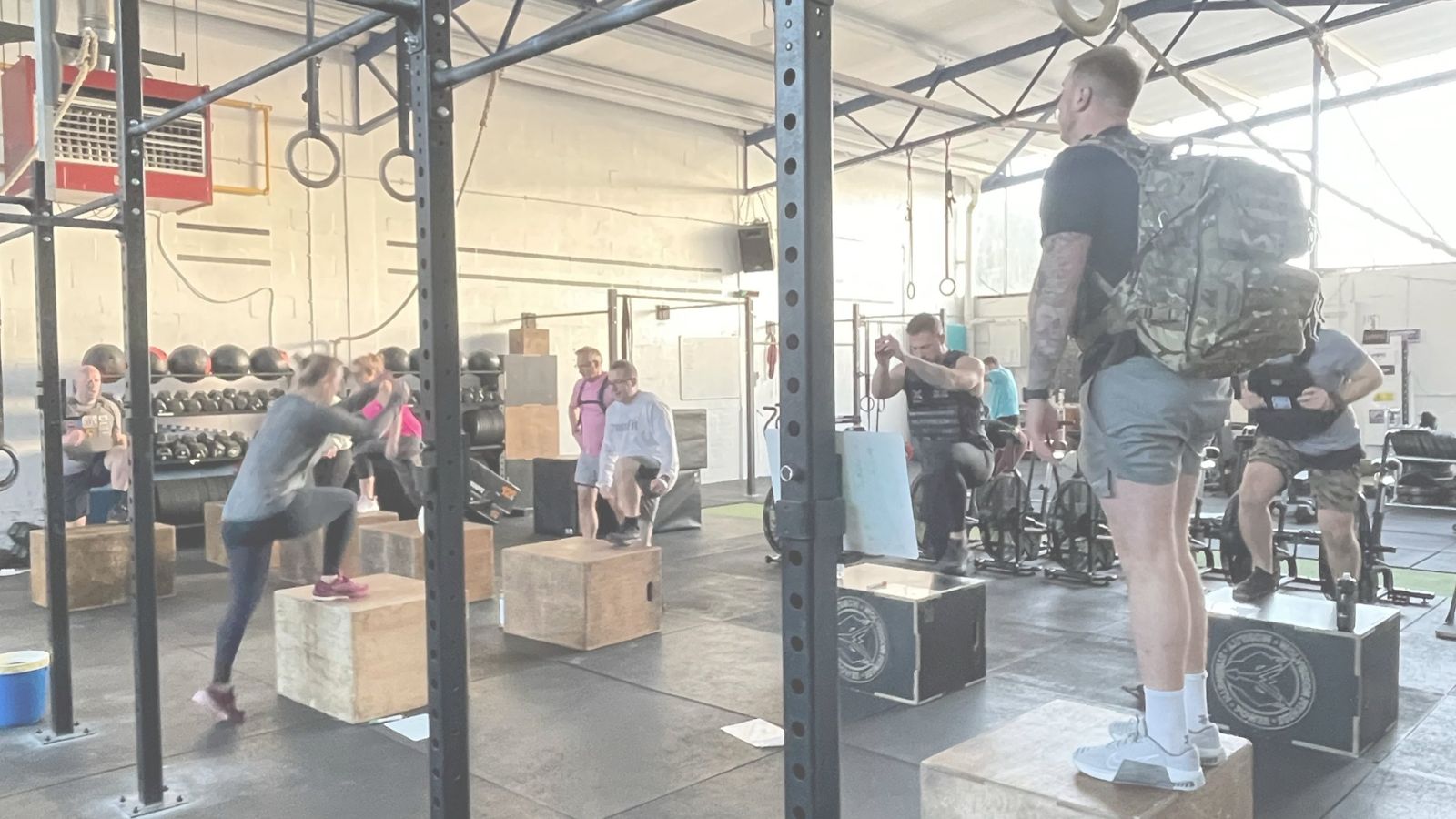 Members doing step-ups together during a coached class at ORE